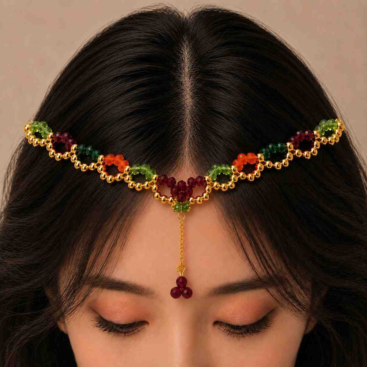 Elegant crystal matha patti styled with a Mehndi hairstyle